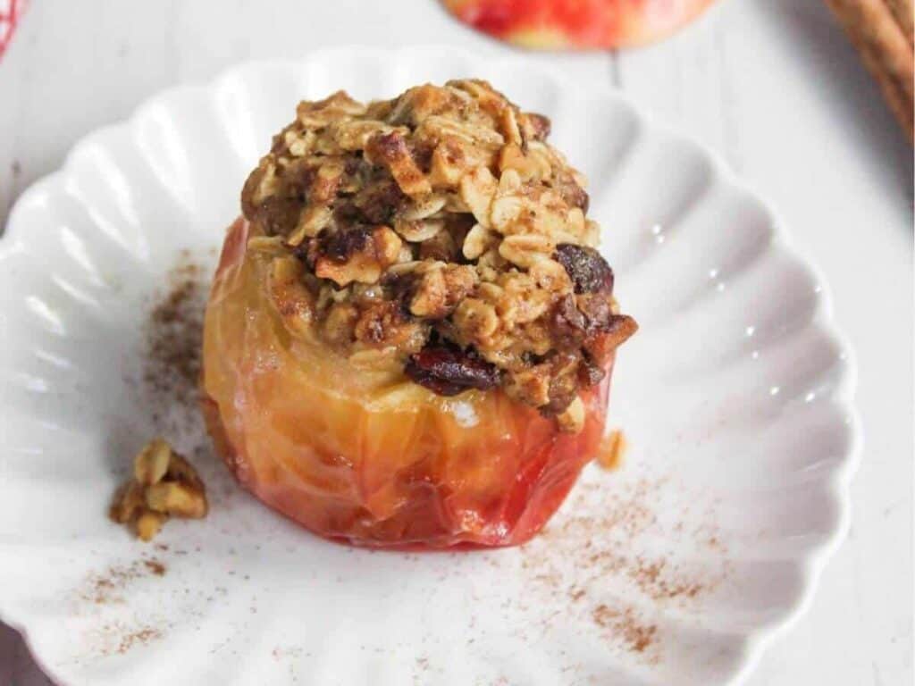 Image shows delicious baked apple in air fryer.