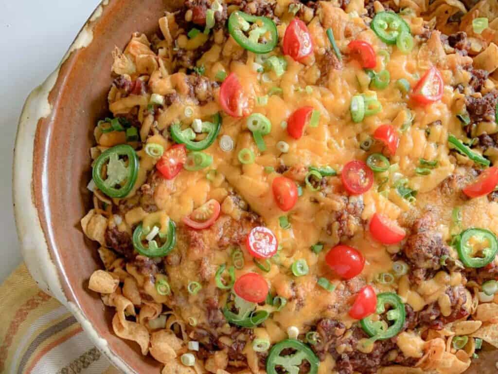 Image shows easy to make tailgater frito pie with cowgirl chili.