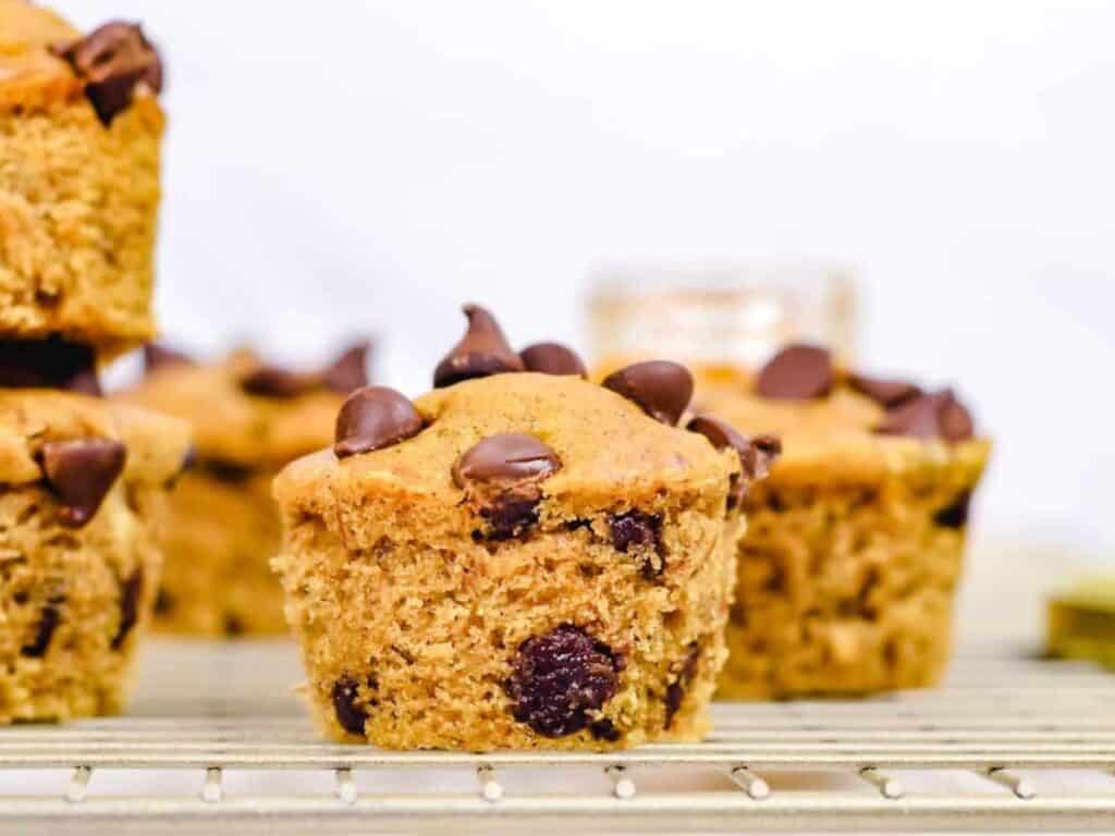 Image shows irresistible chocolate chip banana peanut butter muffin.