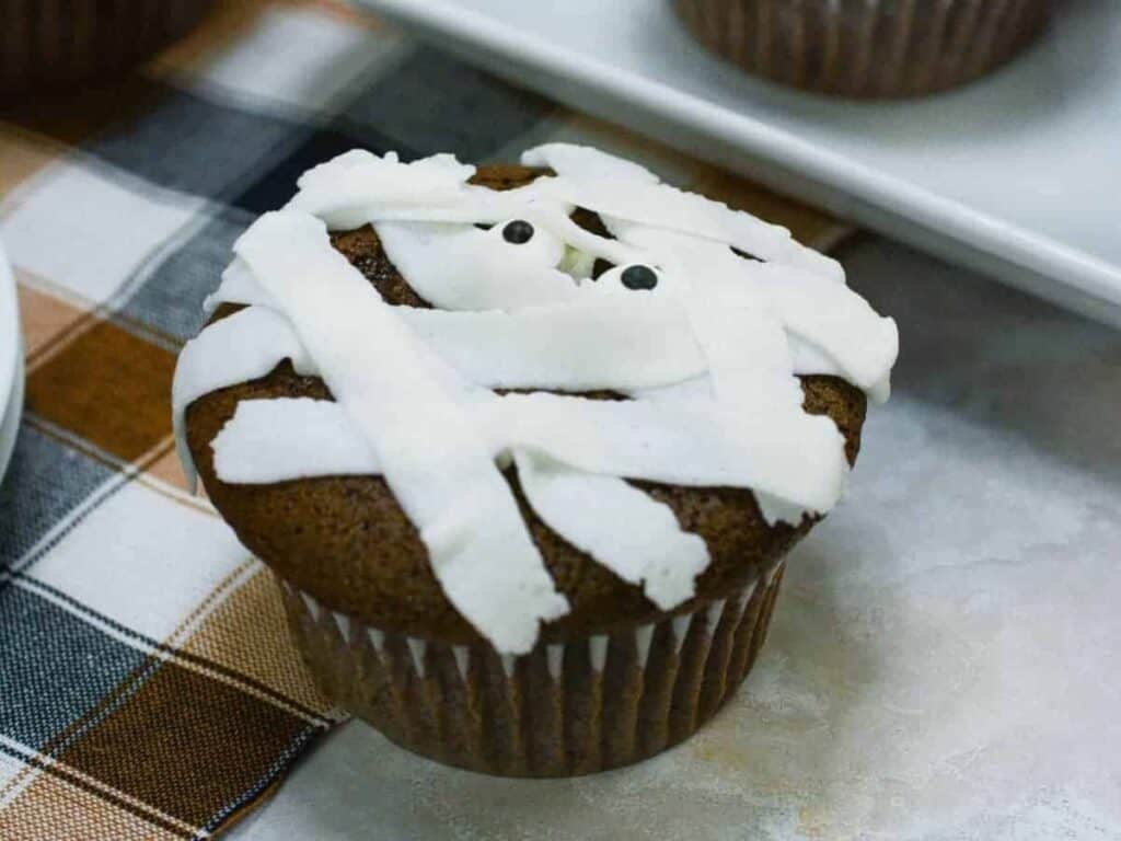Image shows tasty chocolate mummy cupcakes.