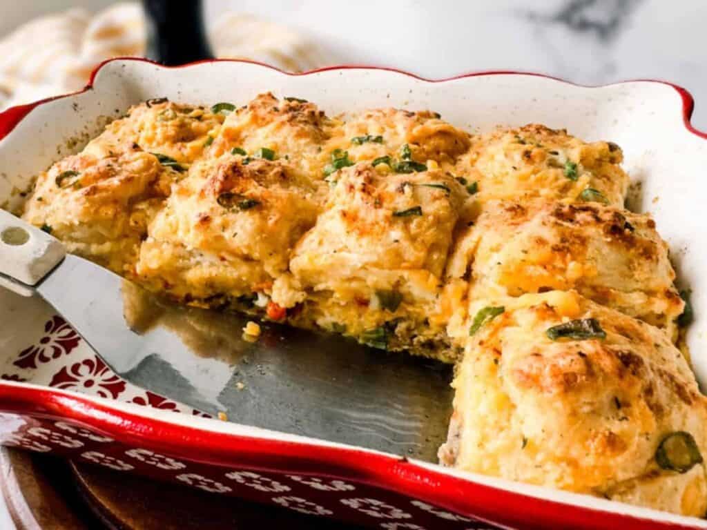 Image shows easy to make cheddar bay breakfast casserole with sausage and eggs.
