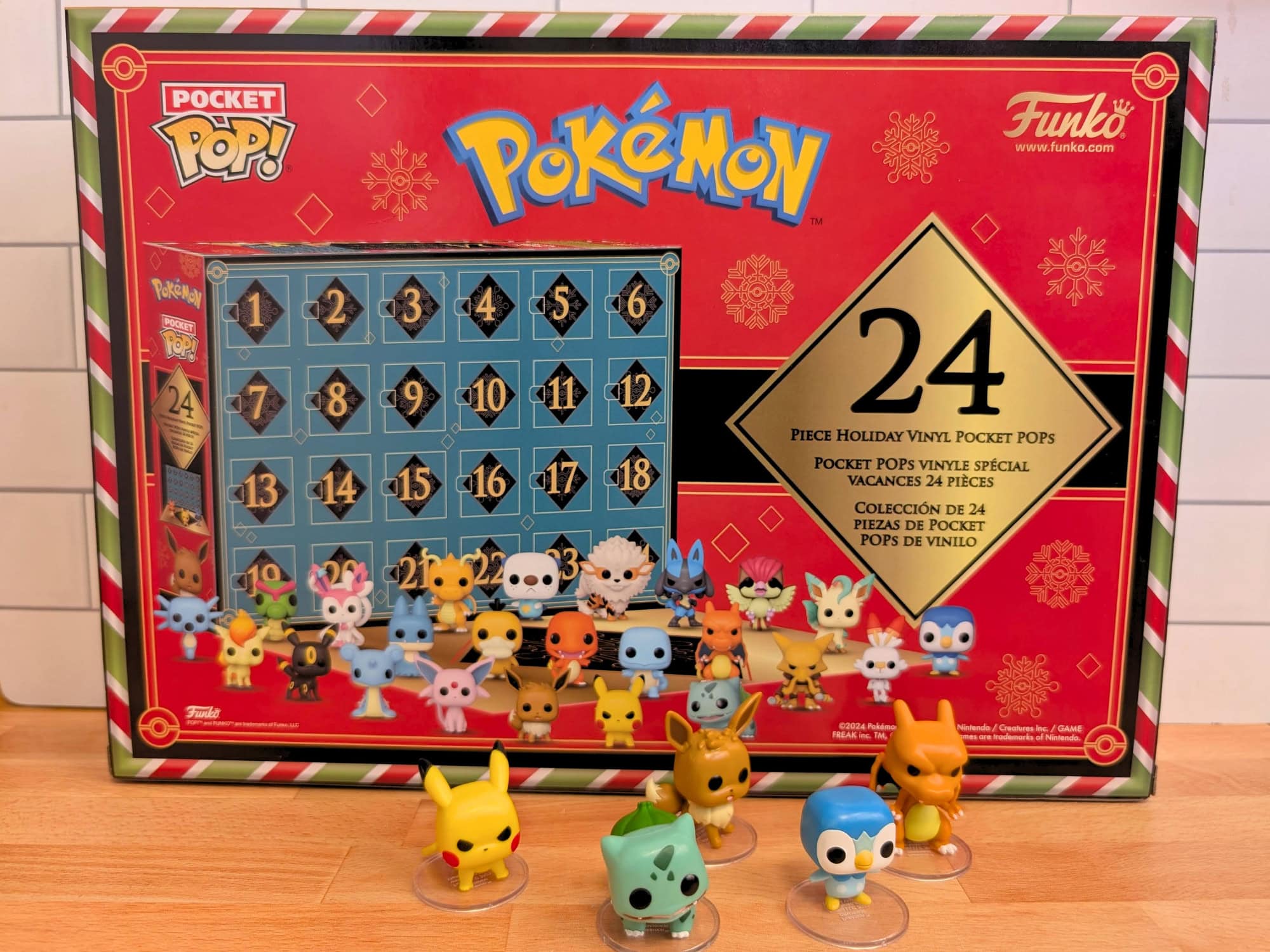 Pok&eacute;mon Funko Pocket Pop advent calendar box featuring 24 numbered doors and various small Pok&eacute;mon vinyl figures displayed in front.
