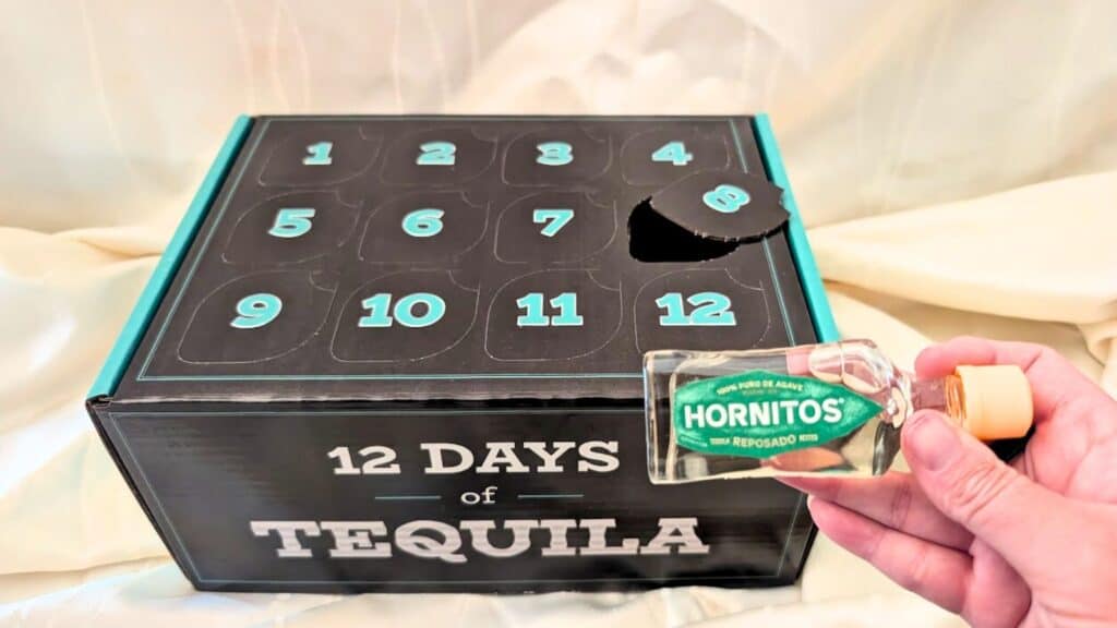 Tequila Advent Calender Product with a bottle of repadado held by a hand.