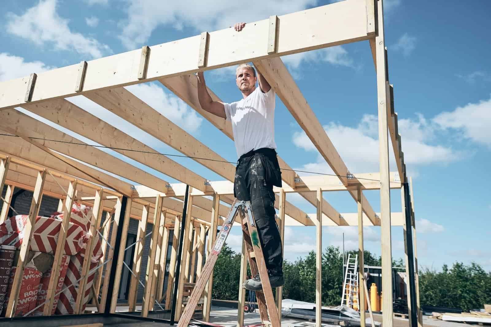 Håndværker på byggeplads, trærammer, konstruktion, New House, professionel byggeri.