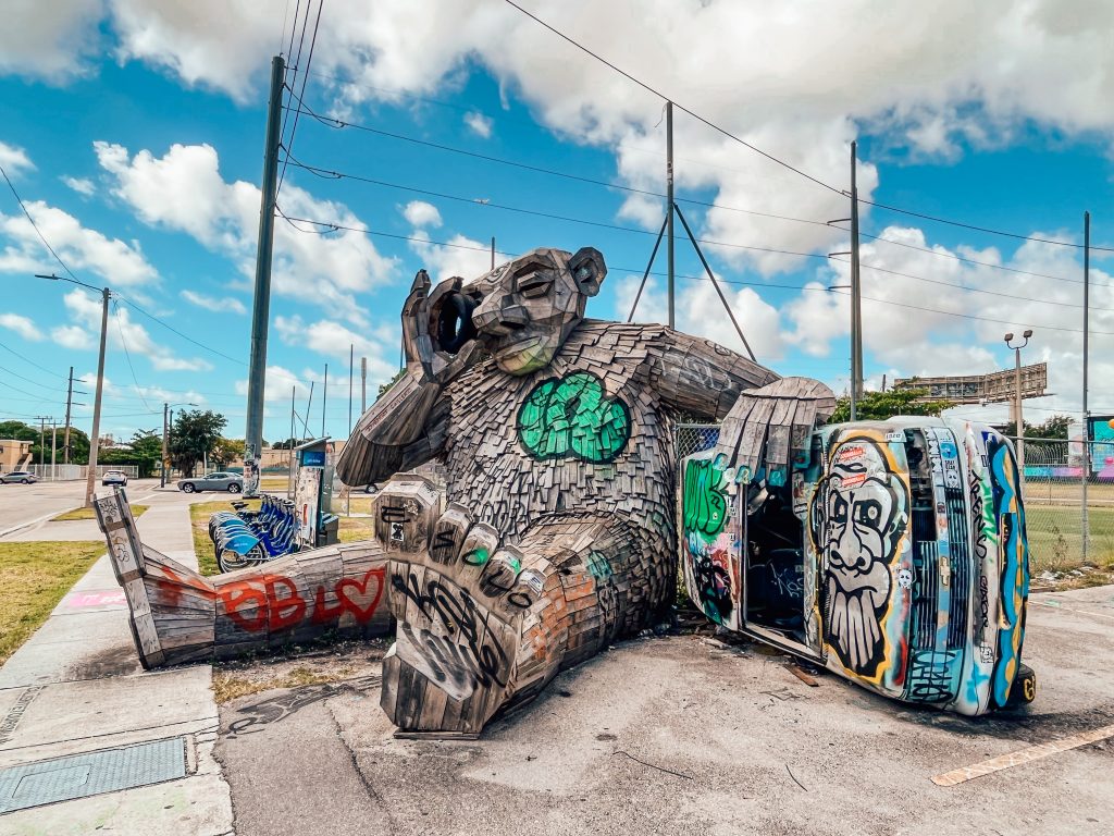 Street art incorporating an overturned car in Wynwood, Miami