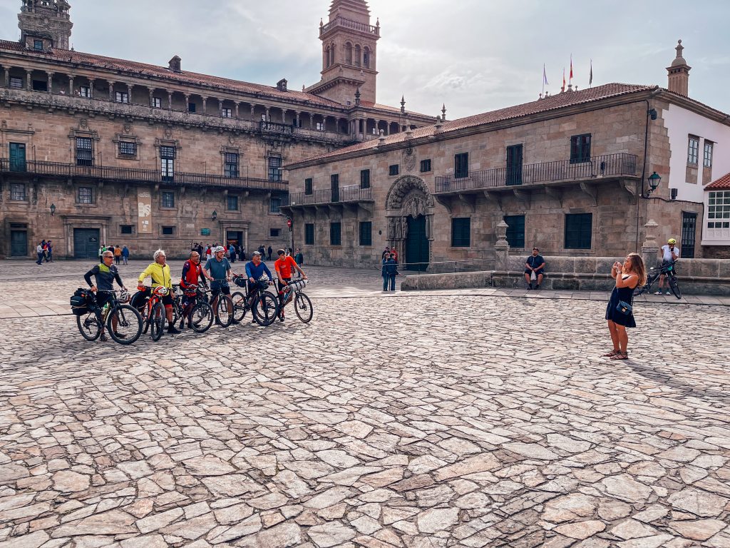 Sofia taking a photo of some cyclists who had just finished the Camino de Santiago