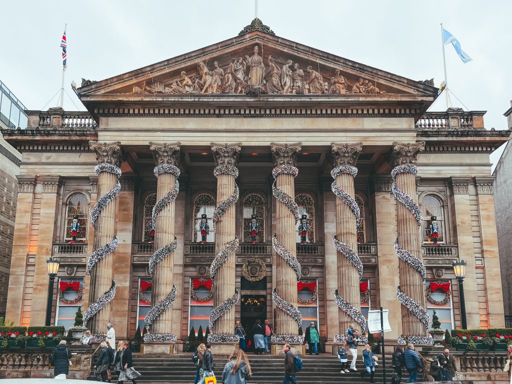 The exterior of the Dome venue in Edinburgh with Christmas decorations covering the columns of the facade