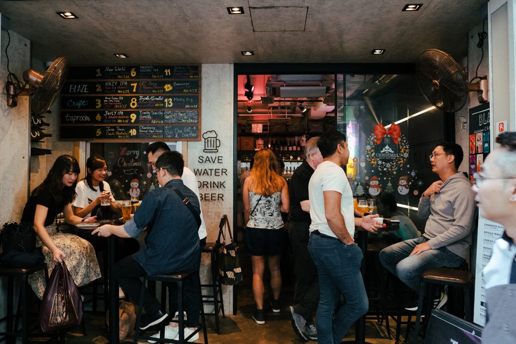 Tables of customers in Hong Kong enjoy craft beer in a local bar.
