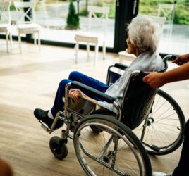 Elderly woman in a wheelchair in a nursing home