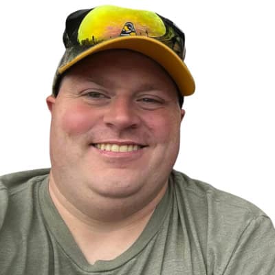 A man wearing a hat and smiling.