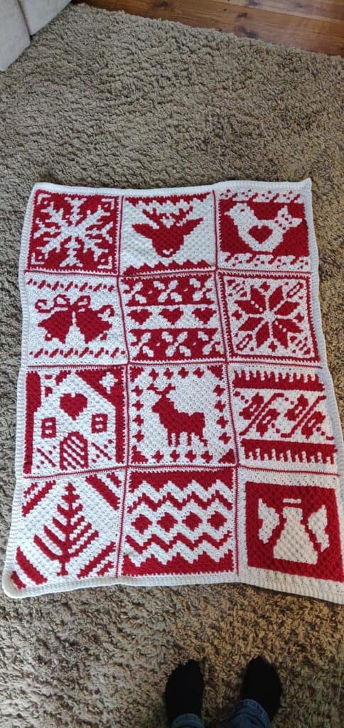 Colorful Nordic Christmas Afghan with reindeer, snowflakes, and holiday motifs.