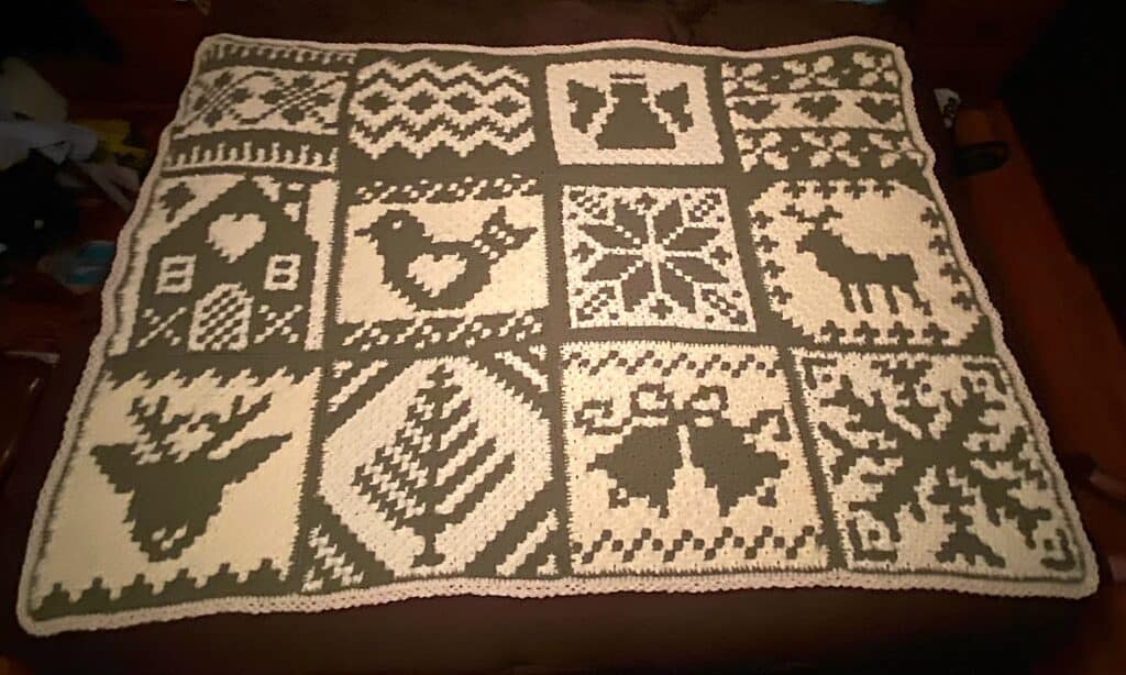 Cozy Nordic winter crochet blanket with festive holiday patterns and reindeer motifs.
