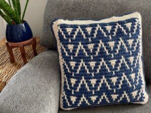 Decorative pillow with blue and white geometric pattern for home decor.
