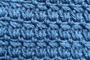 Blue textured woven fabric, detailed close-up of the intricate yarn pattern.