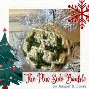 Christmas crochet bauble with green and cream yarns.