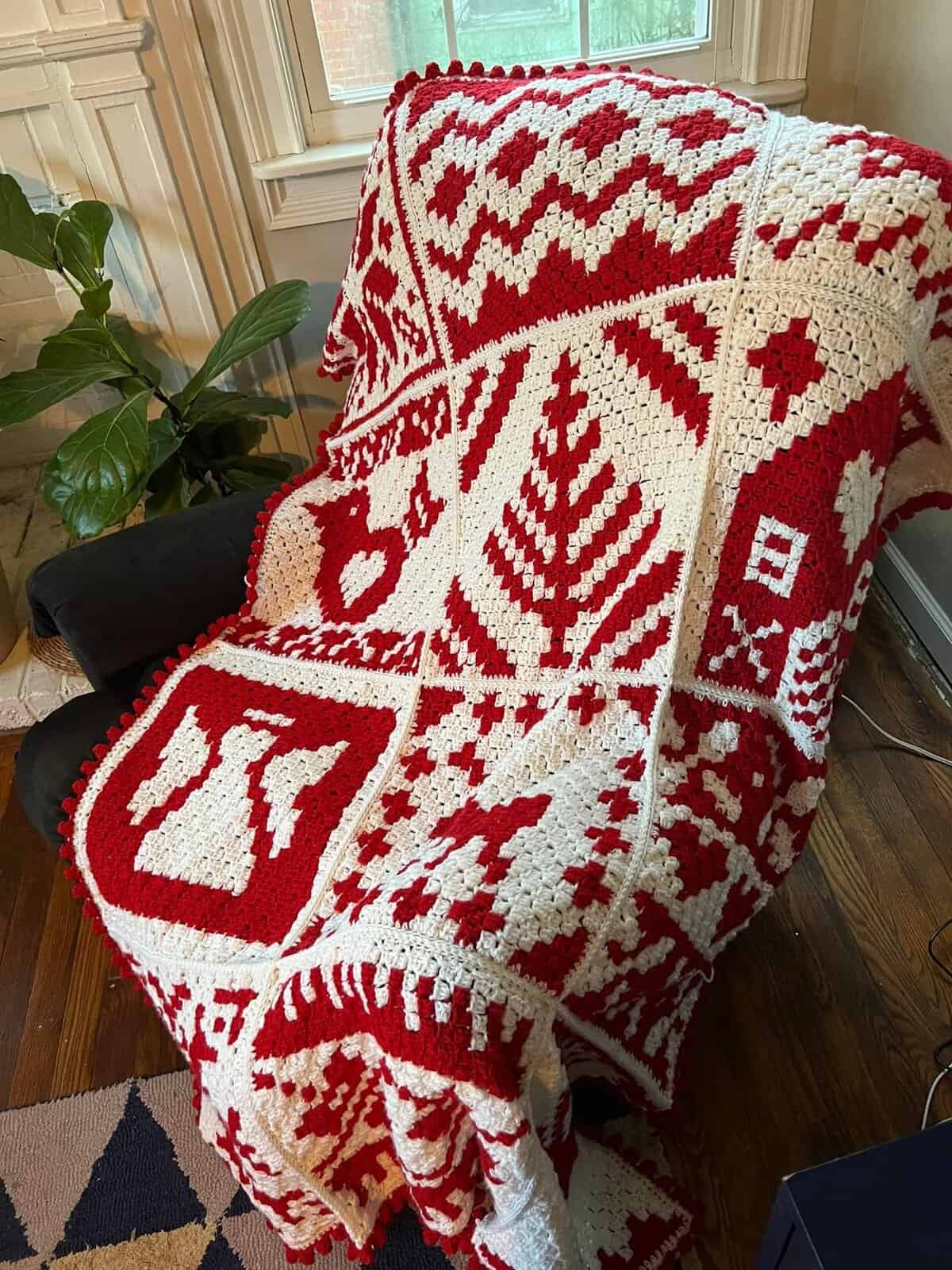 Mosaic Nordic Winter Afghan crochet blanket with red and white geometric patterns.