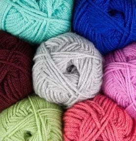 Colorful yarn balls for Daffodil C2C crochet pillow pattern.
