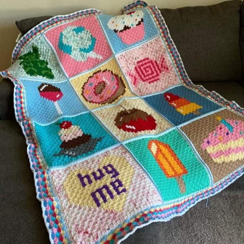Colorful Candy/Dessert Themed C2C (Corner to corner) Crochet Blanket draped over a couch.