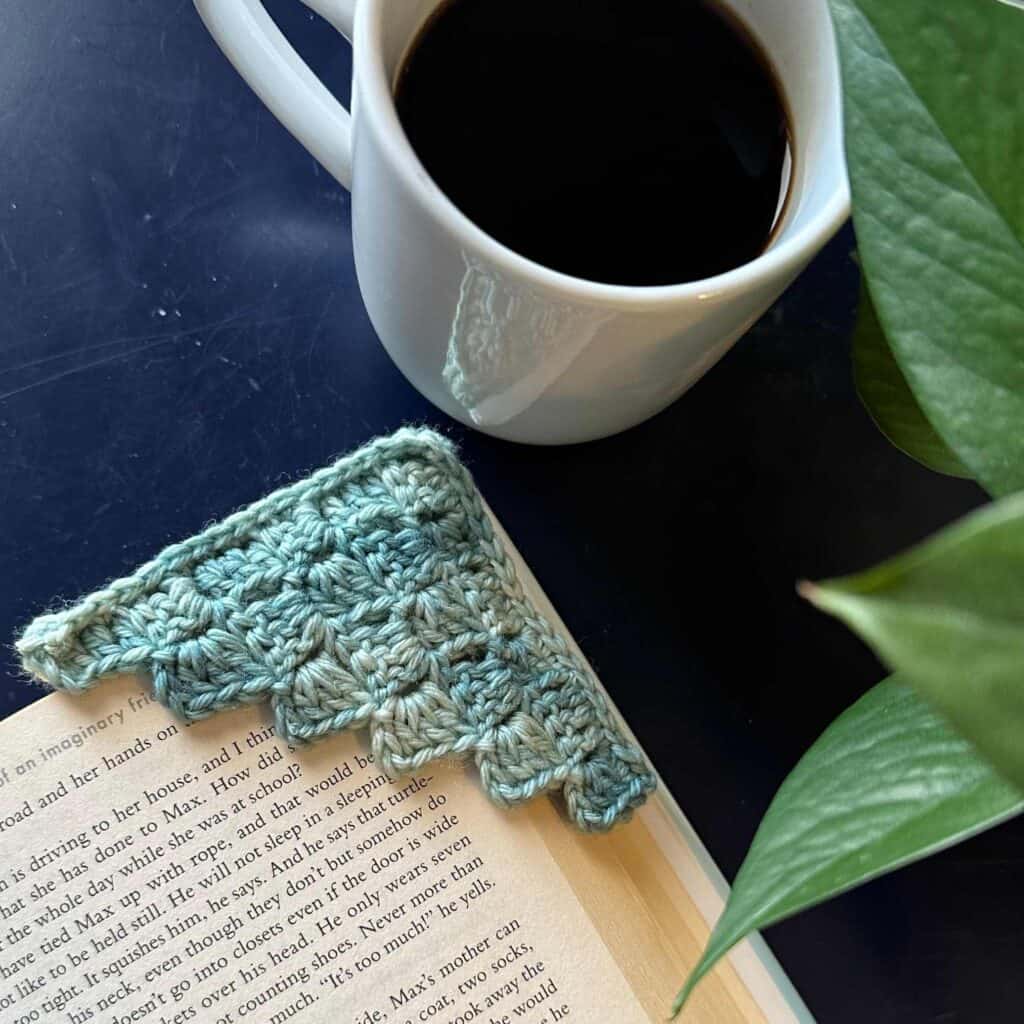 Juniper and Oakes cozy coffee scene with a knitted item and a cup of coffee.