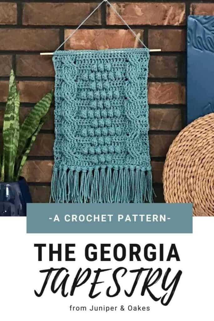Handmade crochet Georgia tapestry hanging on brick wall, decorative home accent.