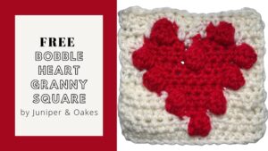 Handmade granny square featuring a red heart motif on a white background, crafted with yarn.