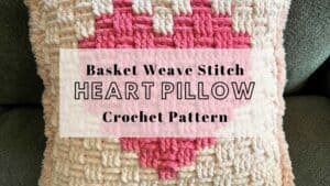 Heart pillow with basket weave stitch in pink and cream colors, perfect for home decor or gift-givin.