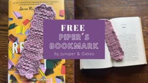 Handmade purple crochet bookmark from Juniper & Oakes on open book.