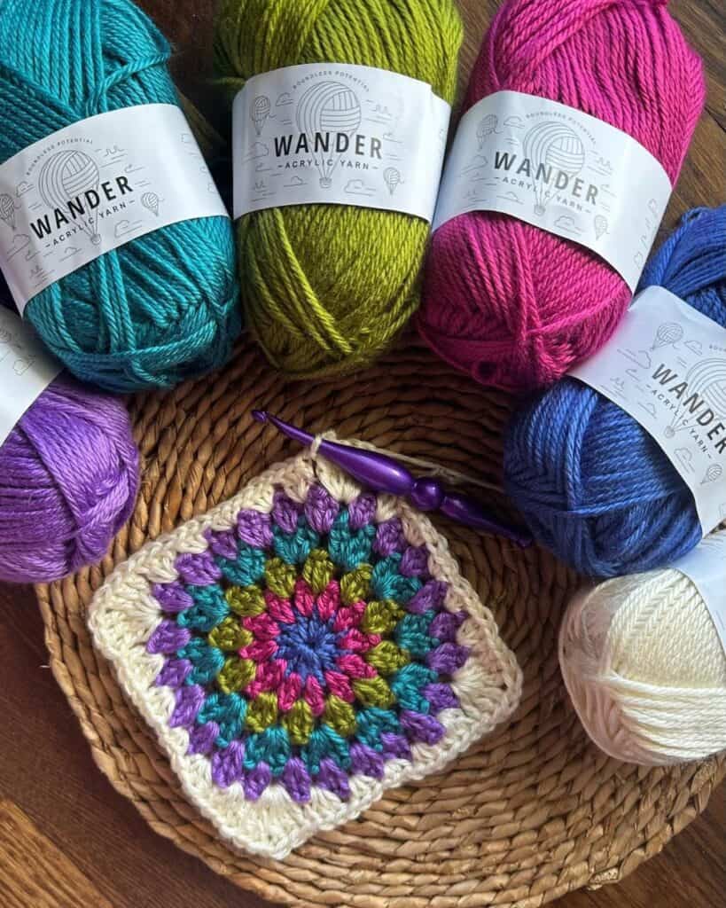 Vibrant yarns and a handmade crochet square for knitting or crochet projects.