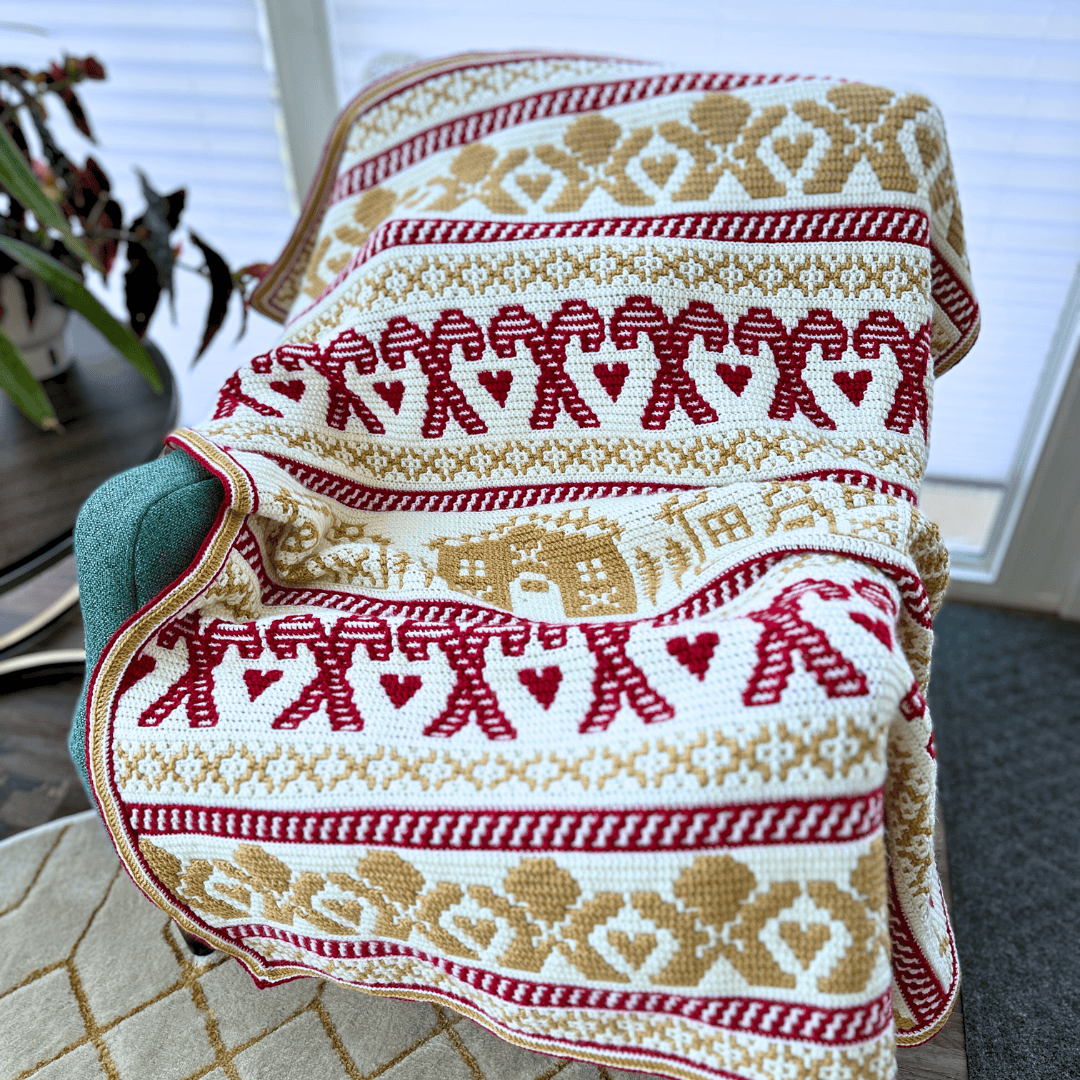 Festive mosaic crochet gingerbread blanket with red and gold patterns.