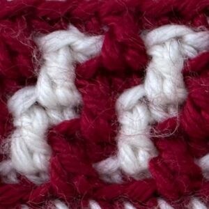Close-up of red and white crochet yarn for gingerbread blanket pattern.