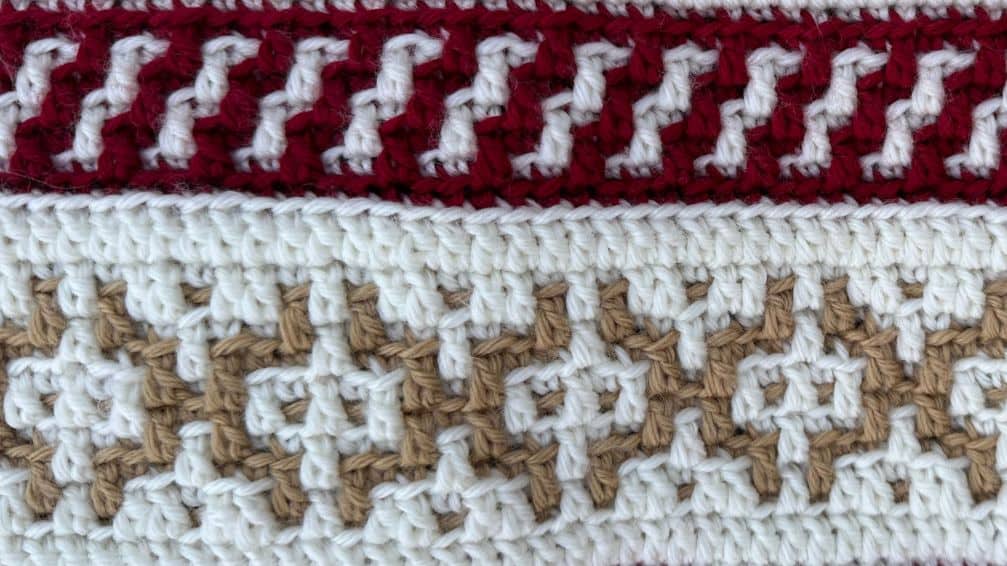 Close-up of a gingerbread-themed mosaic crochet blanket in warm tones.