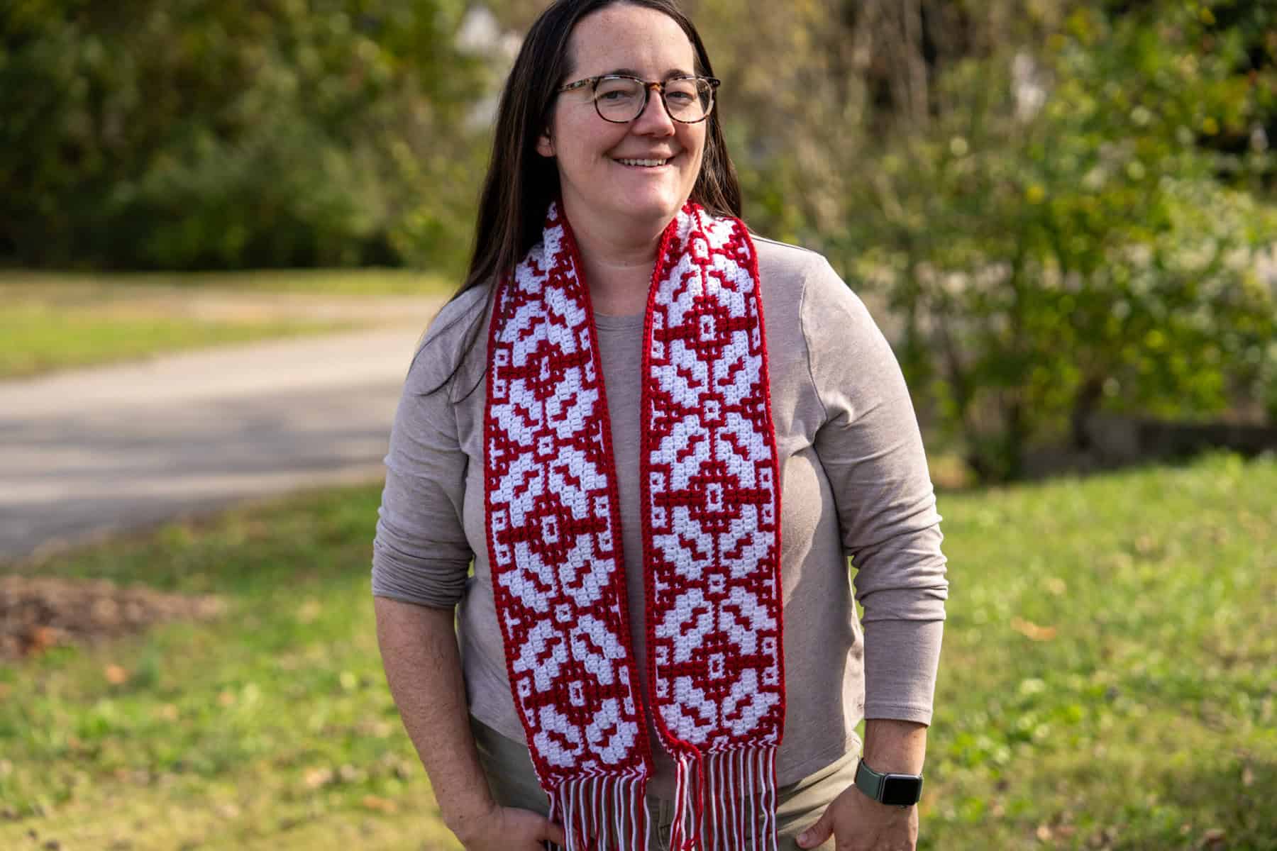 Vibrant red and white mosaic crochet scarf with festive holiday patterns. Perfect for Christmas cele.