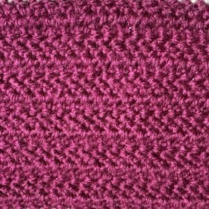 Bright pink crochet shell stitch close-up.