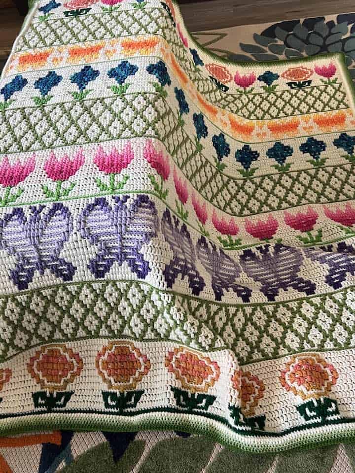 Vintage embroidered textile with colorful floral patterns and geometric designs.