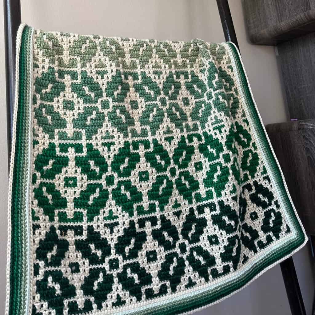 Elegant Nordic Star crochet blanket in green and white.