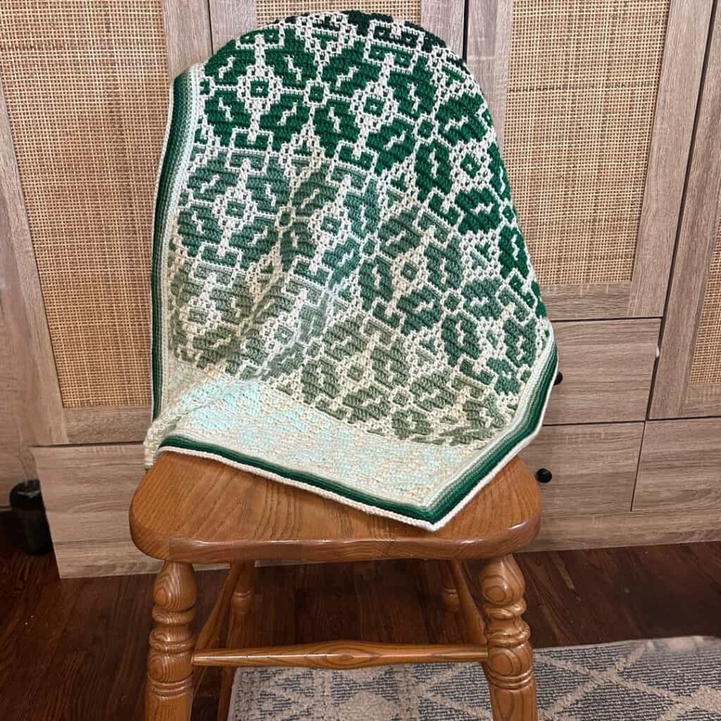 Nordic Star Baby Blanket draped over a chair