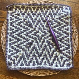 Handmade crochet mosaic ZiggyZag blanket square with intricate pattern.