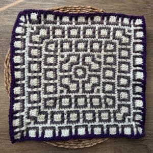 Decorative crochet mosaic square with geometric design, perfect for blankets or wall art.