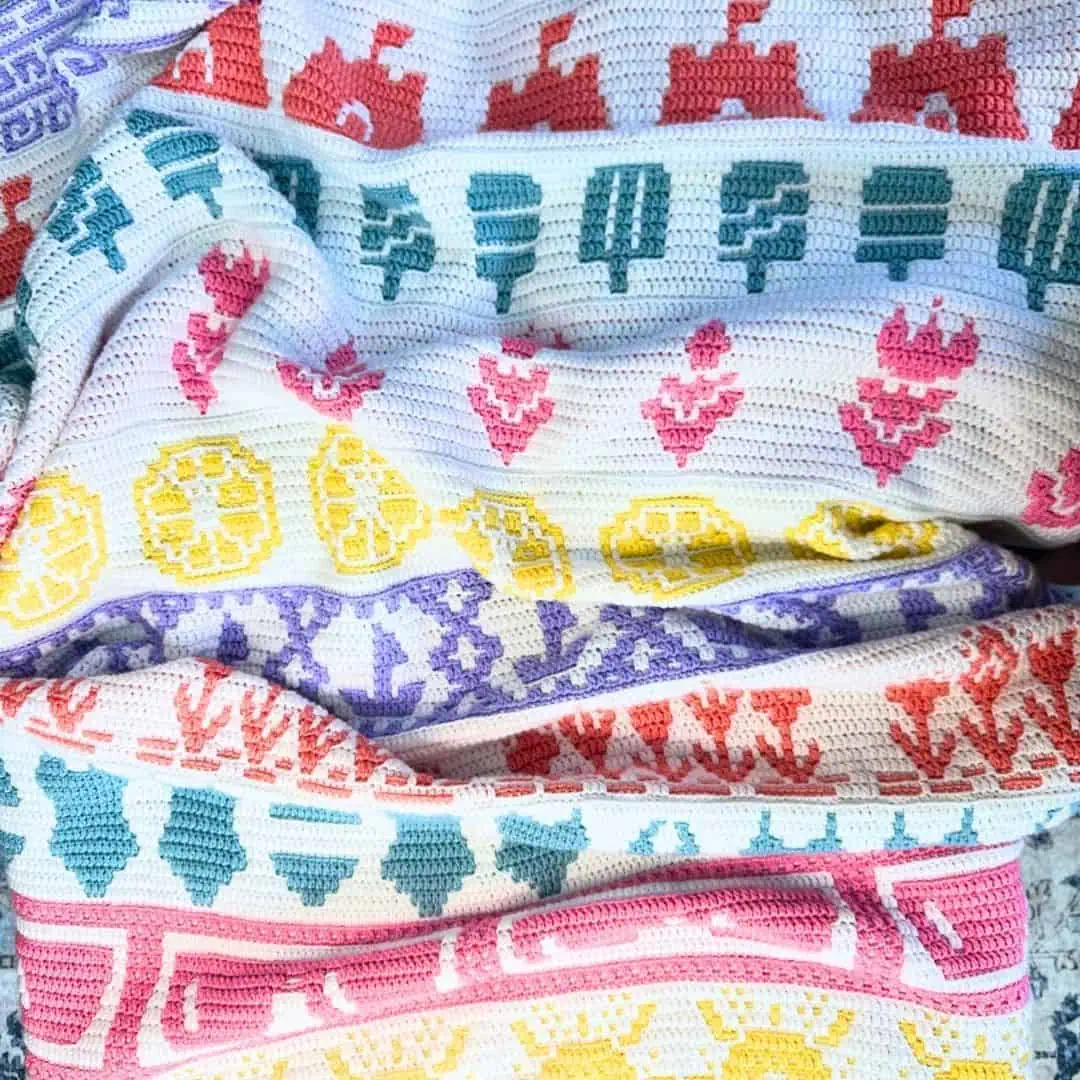 Colorful mosaic fabric art featuring summer-themed patterns and vibrant hues.
