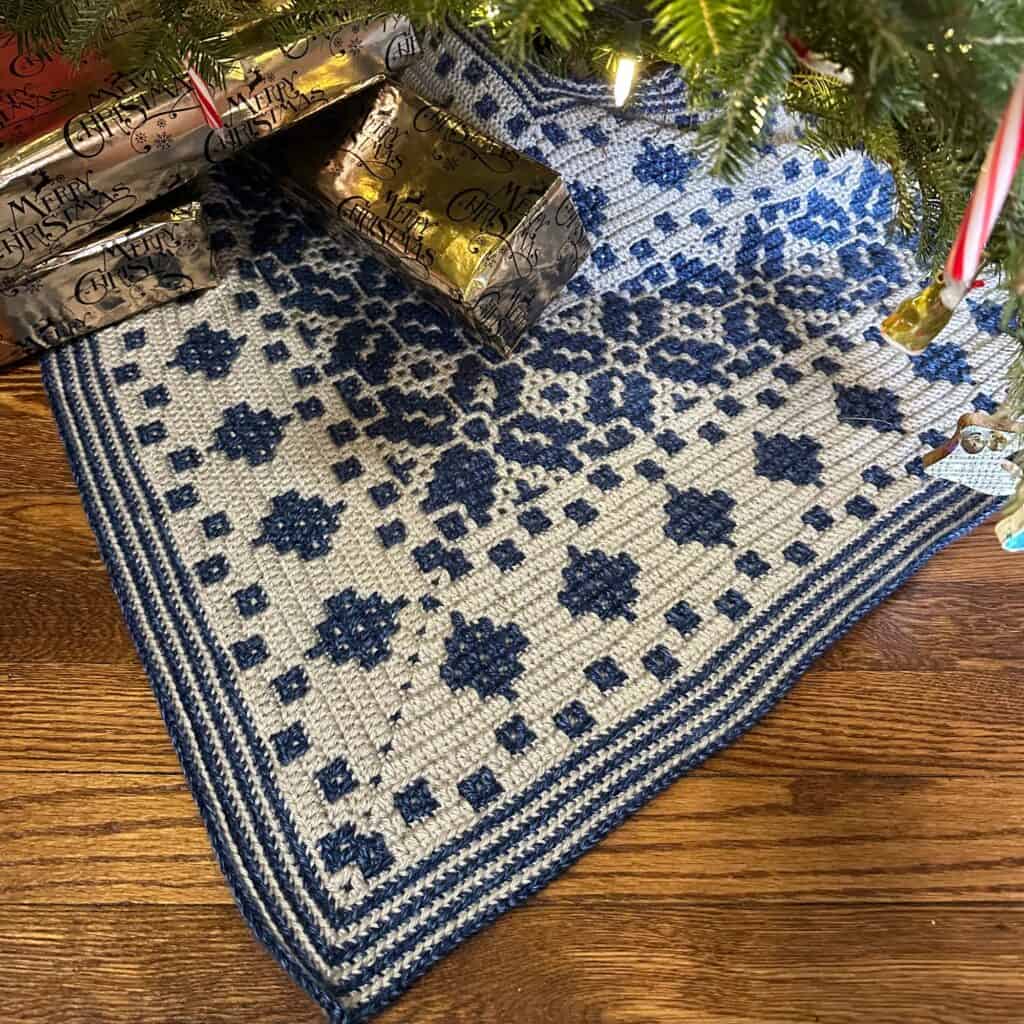 Nordic star Christmas tree skirt with blue and gray mosaic crochet pattern.
