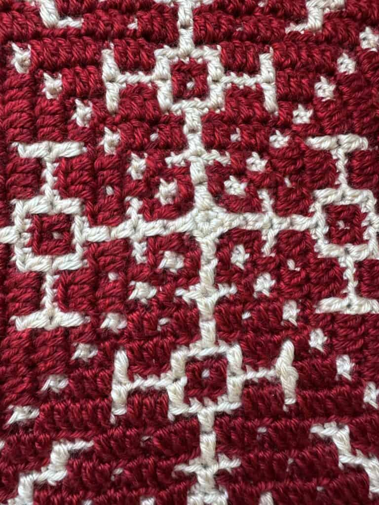 Crochet snowflake square pattern in red and white yarn for mosaic projects.