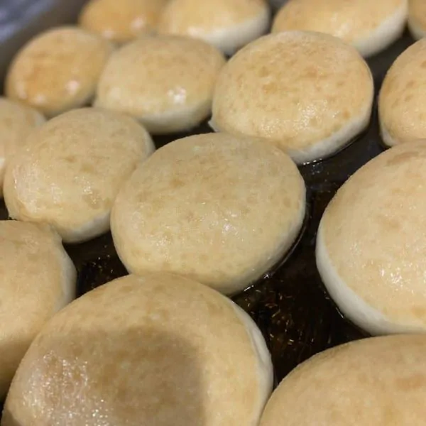 Close-up of golden, soft donuts fresh out of the oven at Knead Donuts.