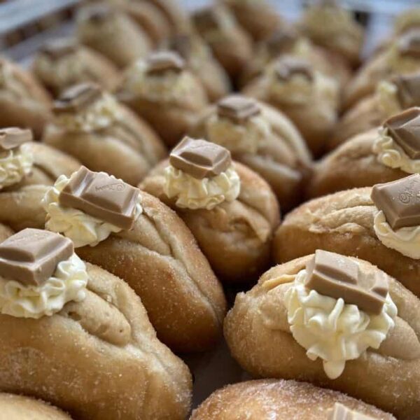 Delicious NZ donuts with cream and chocolate, perfect for any occasion.