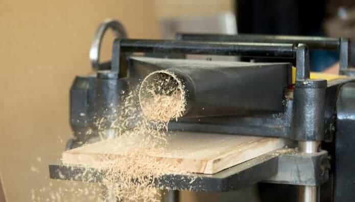 stationary power woodworking planer processing wooden flooring board making sawdust 2
