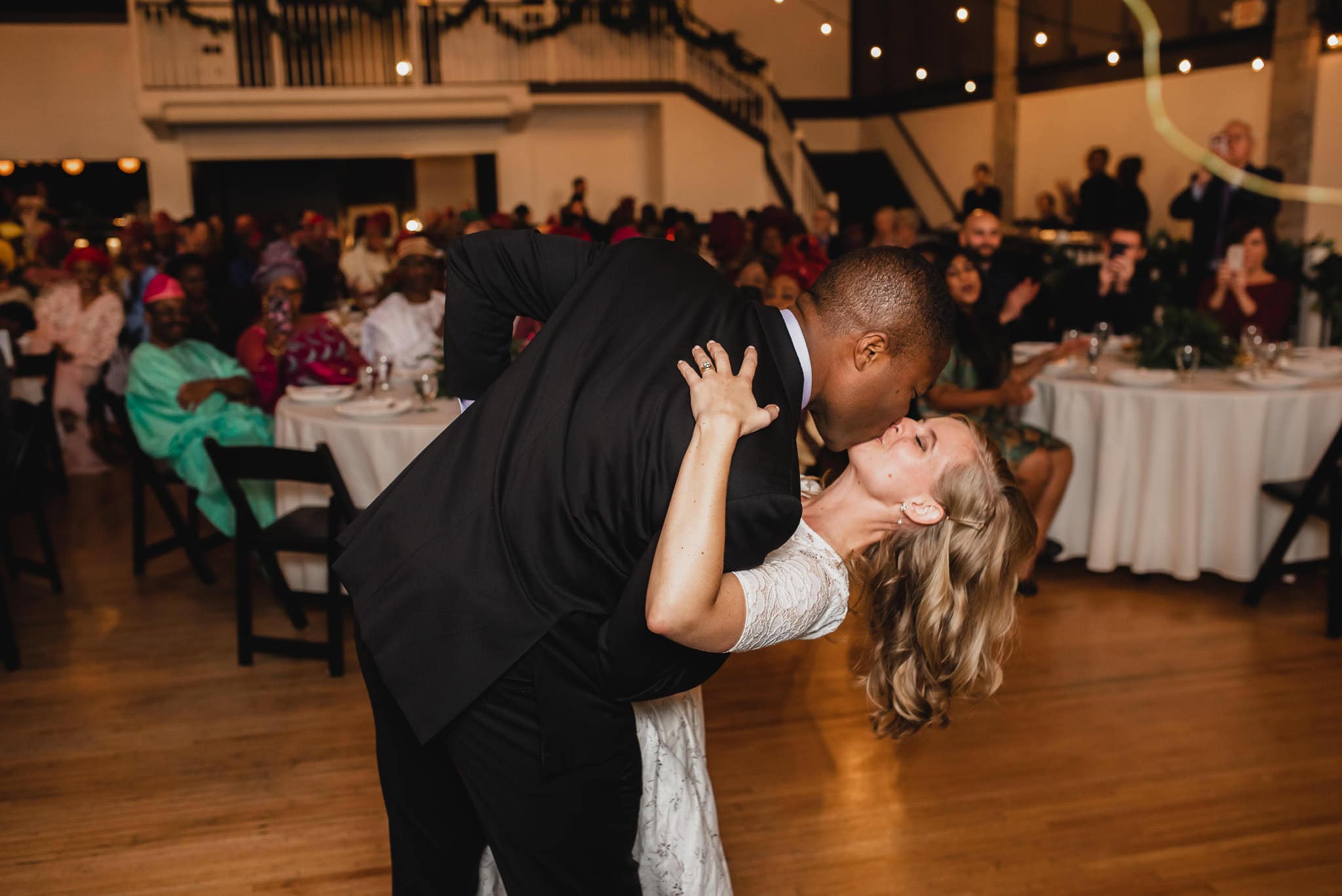 At the wedding at the Evergreen, a couple danced and shared a kiss on the wooden floor, surrounded by delighted guests.