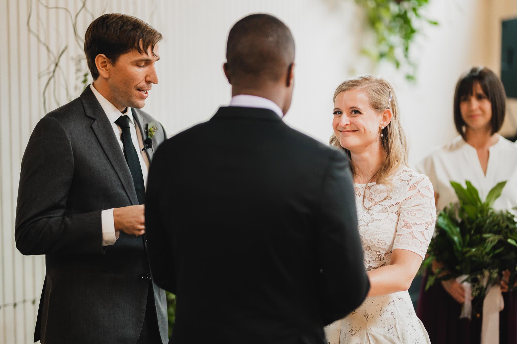 The couple exchanged vows at the wedding at the Evergreen, with a smiling woman in a white dress and a man in a suit.
