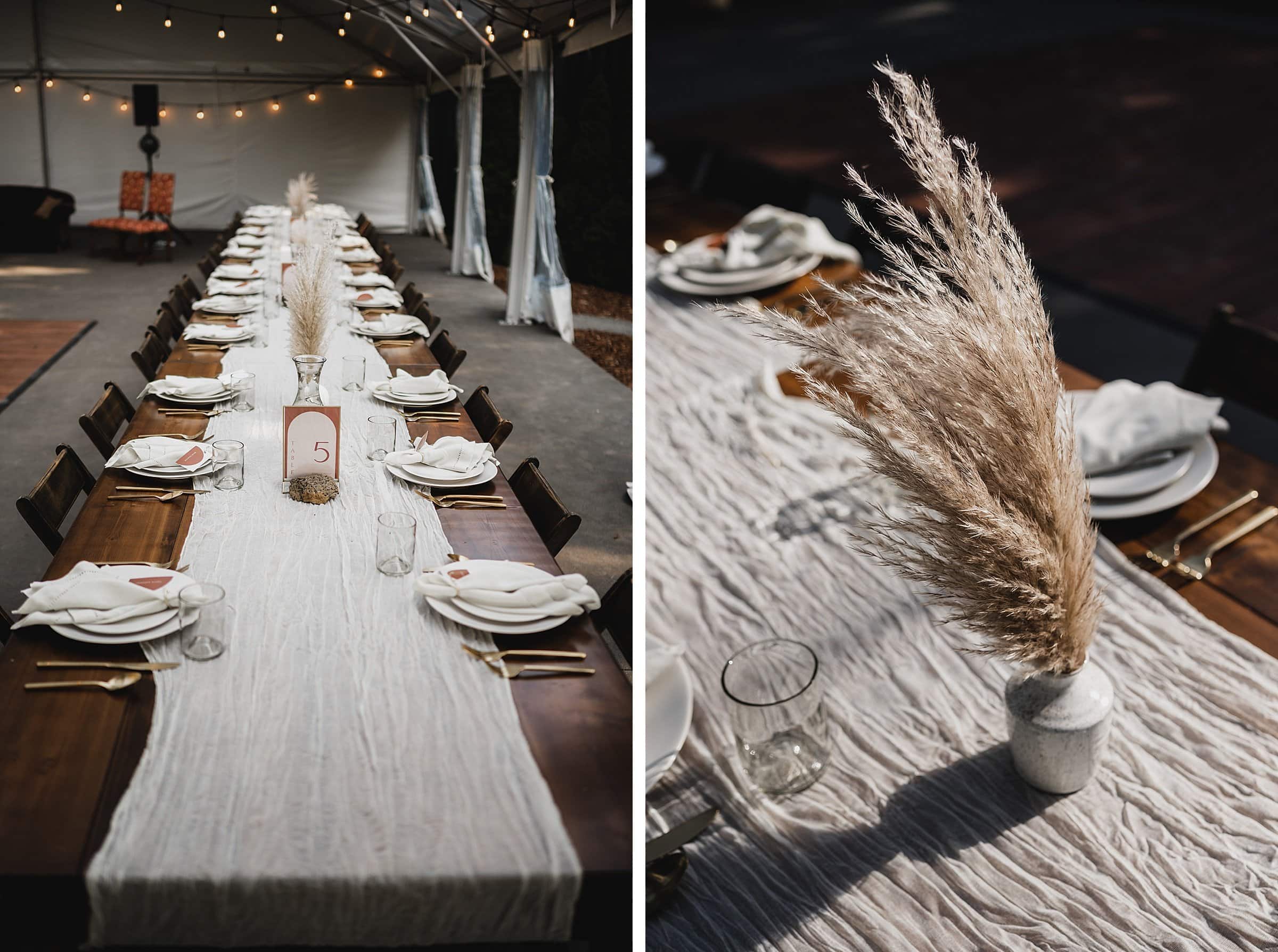 A long wooden table adorned with pampas grass centerpieces and elegant table settings sits under a tent with string lights, perfect for capturing stunning wedding photos at The Griffin House.