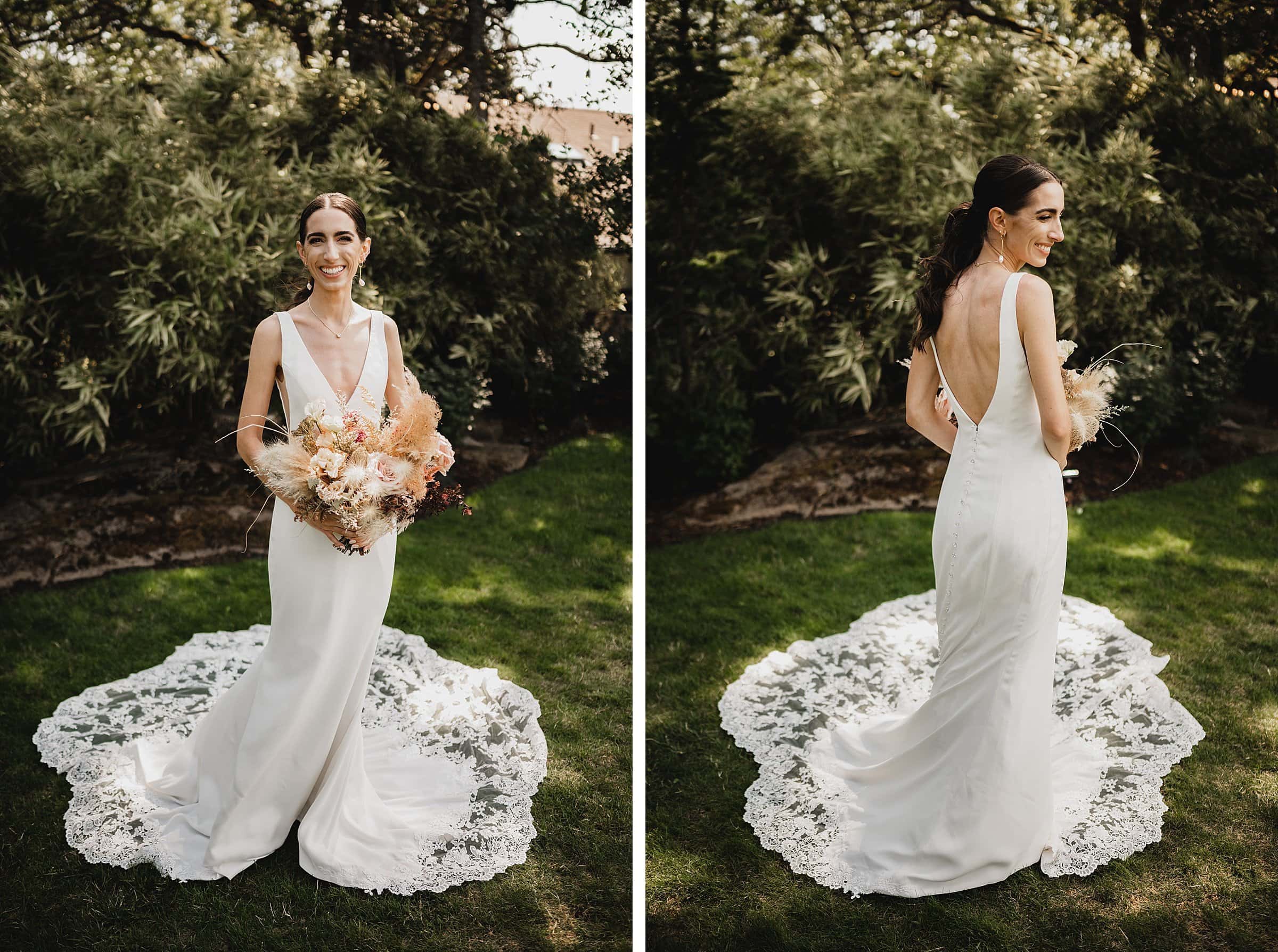 The bride in a white lace gown holds a bouquet, standing on the lush grass with greenery in the background at The Griffin House, smiling and posing for her wedding photos.