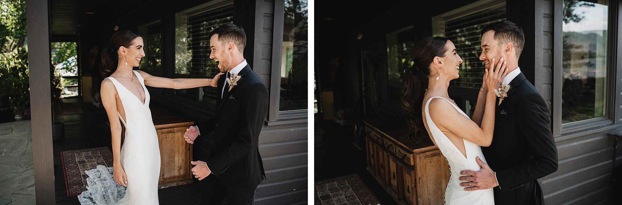 The bride and groom share a joyful first look moment near a dark-painted house at The Griffin House, embracing and smiling.