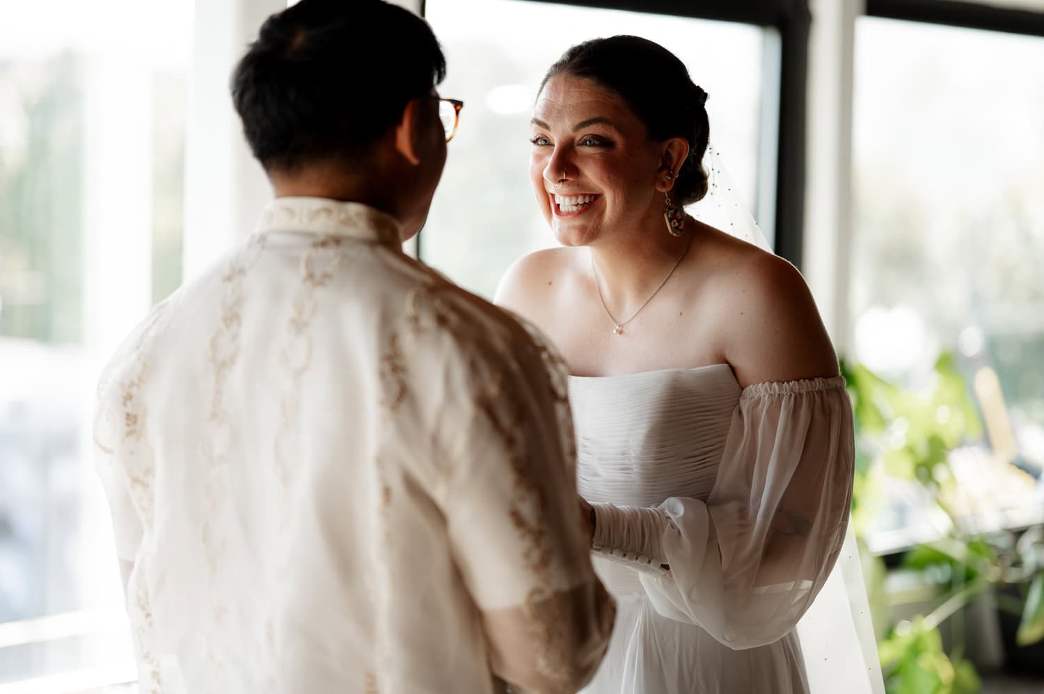 The bride and groom smiled warmly at each other during their wedding ceremony at Union/Pine.